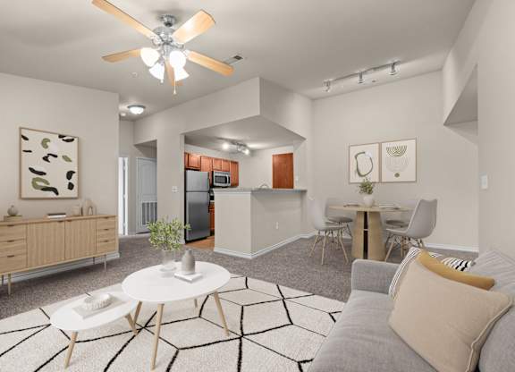 A modern living room with a grey couch and a white coffee table.