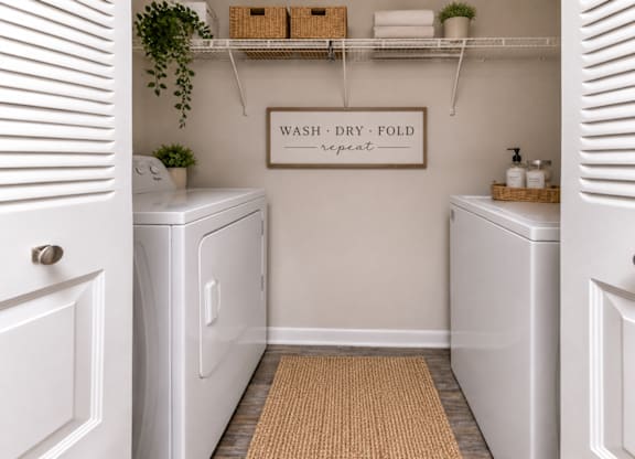 A laundry room with a sign that says