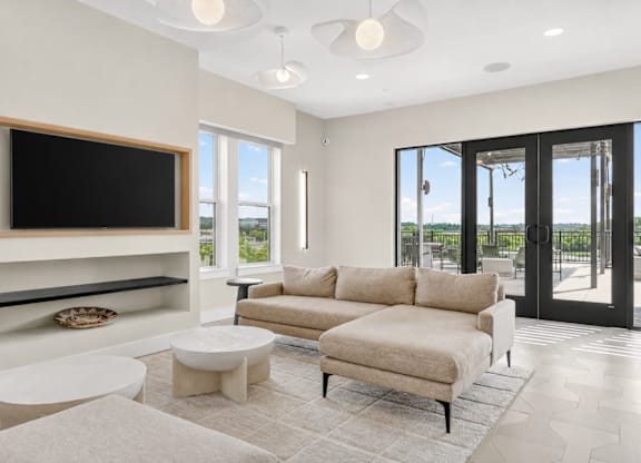 A living room with a large television and a couch.