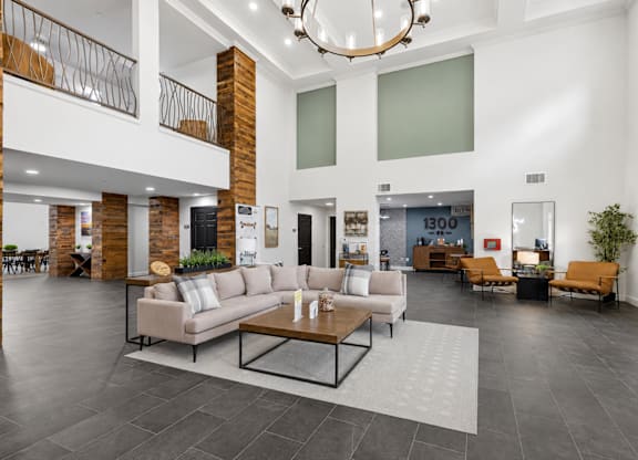 A spacious living room with a large sofa set and a coffee table.