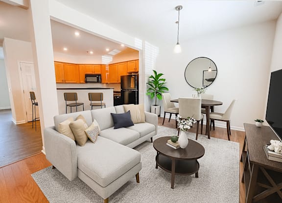 A living room with a grey couch and a coffee table.