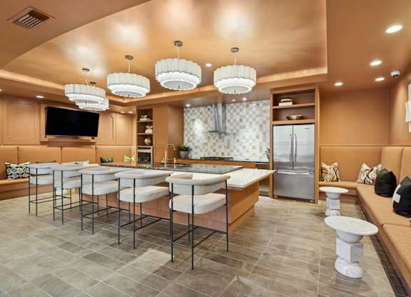 A modern kitchen with a bar area and a refrigerator.