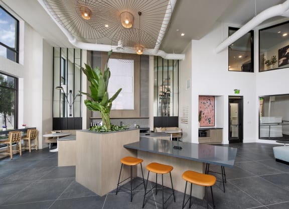 a lobby with a table and four stools
