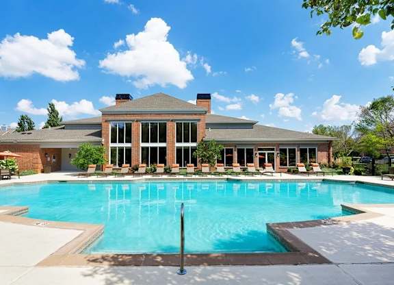 A large house with a pool in front.