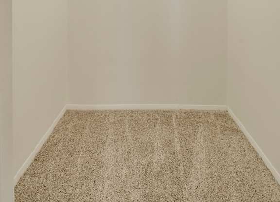 A carpeted hallway with a light on the ceiling.