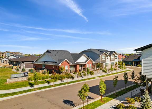 A row of houses with a clear blue sky above them.