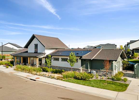 A row of houses with a clear blue sky above them.