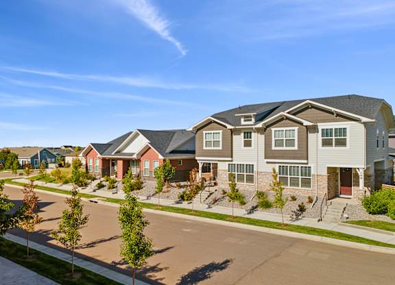 A row of houses with a clear blue sky above them.