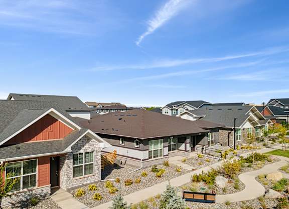 A sunny day at a residential complex with houses and a clear blue sky.