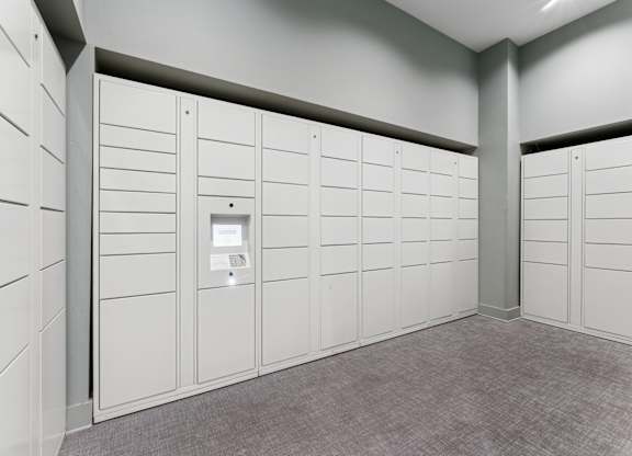 A row of white lockers in a room.