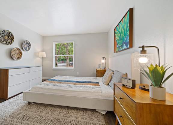 a bedroom with a bed and dresser