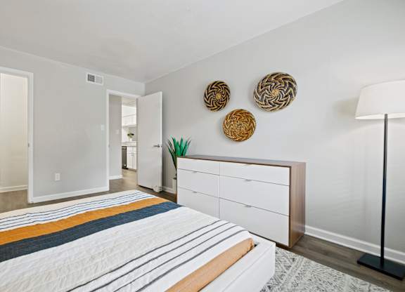 a bedroom with a bed and a dresser