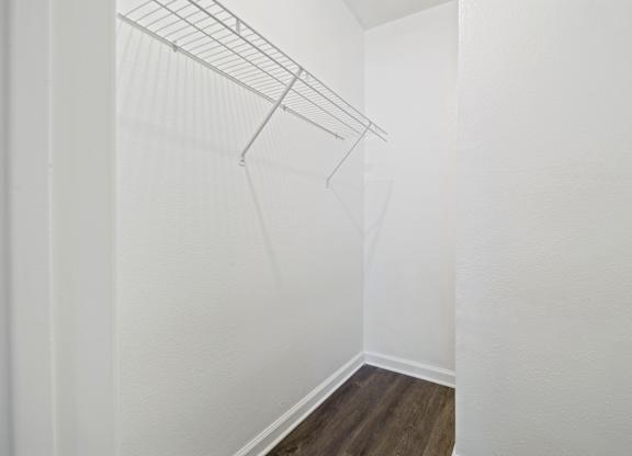 a bedroom with a medium hardwood floor and white walls
