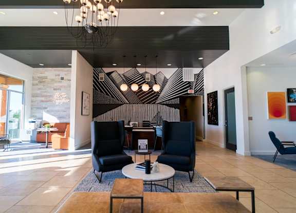 A modern living room with a black and white striped wall.