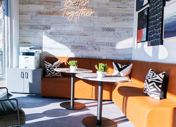 A modern living room with a stone wall and a neon sign that says