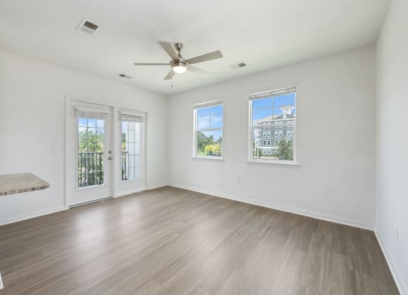 a living room with hardwood floors and white walls