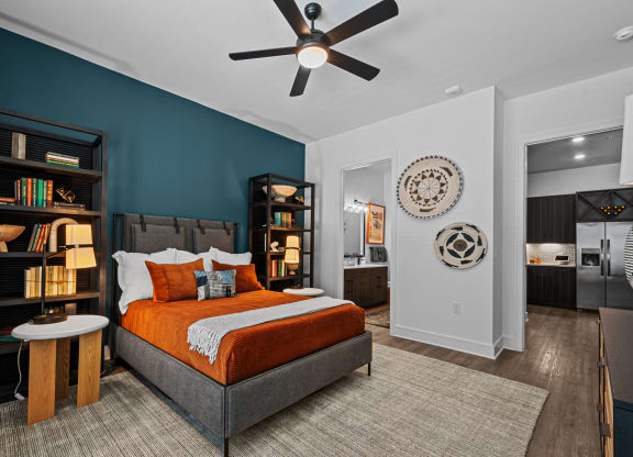 a bedroom with a bed and a ceiling fan