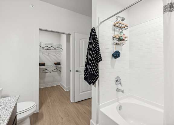 A white bathroom with a toilet, sink, and a bathtub.