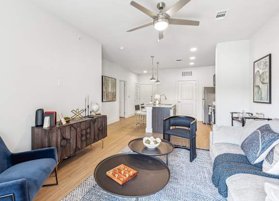A living room with a blue couch and a coffee table.