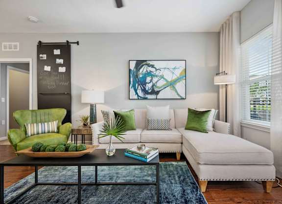 a living room with a couch coffee table and a chair