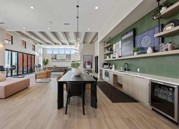 a dining room and living room with a black table