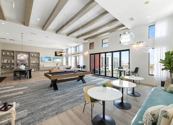 a living room with a pool table and couches