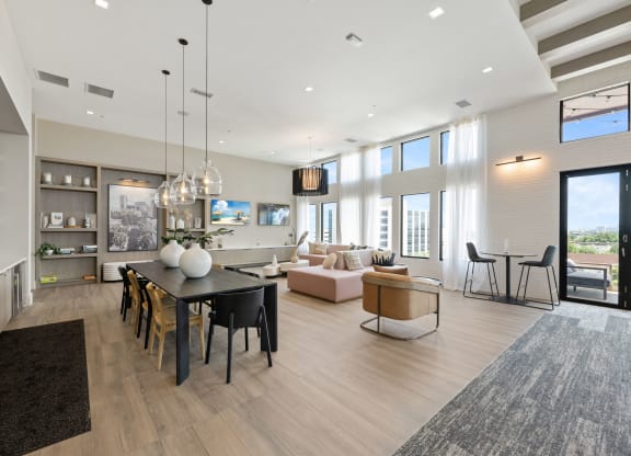 a living room and dining room with a table and chairs