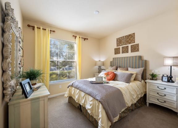 A queen sized bed in a spacious bedroom