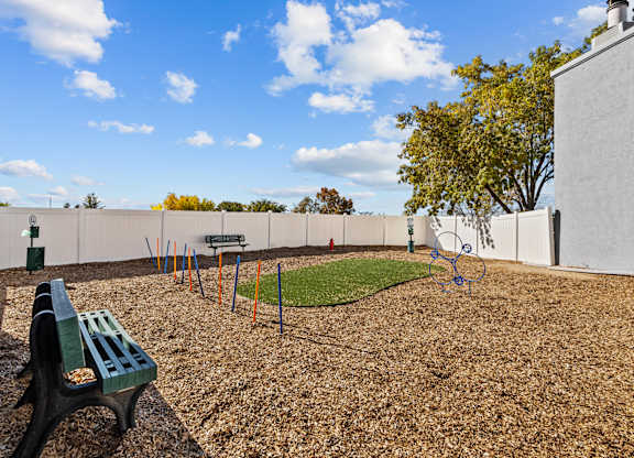 a park with a playground and a bench