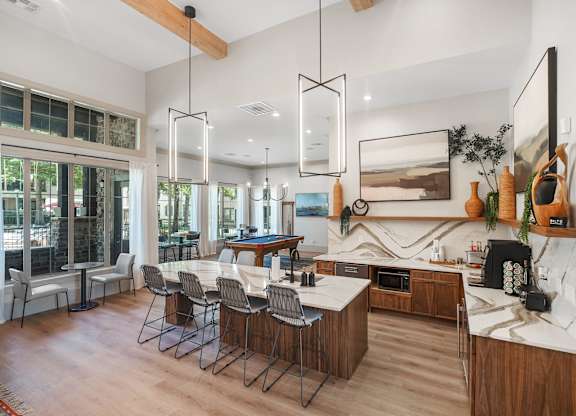 A modern kitchen with a dining table and chairs.