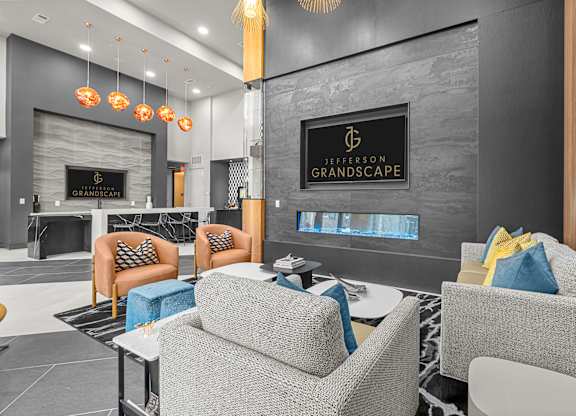 A modern lounge area with a fireplace and comfortable seating.