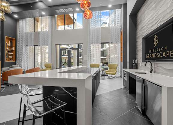 A kitchen with a counter and chairs and a sign that says Jefferson Grandscape.