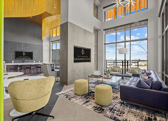 A living room with a yellow chair and a purple couch.