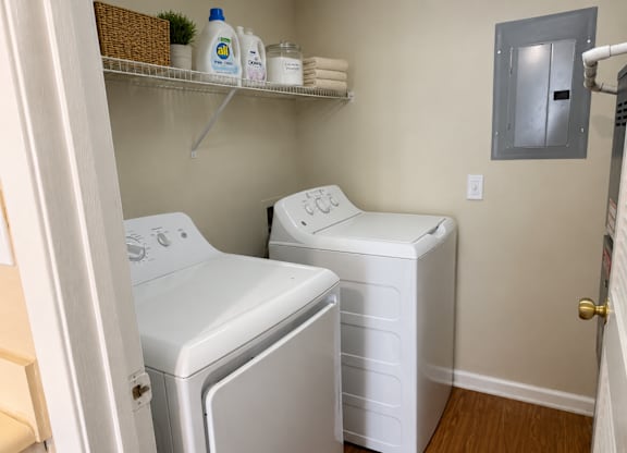 A small laundry room with a washer and dryer.
