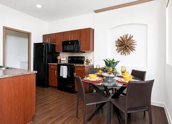 A kitchen with a table set for two.