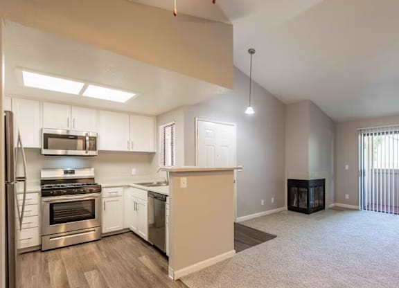 A spacious kitchen with stainless steel appliances and a large island.