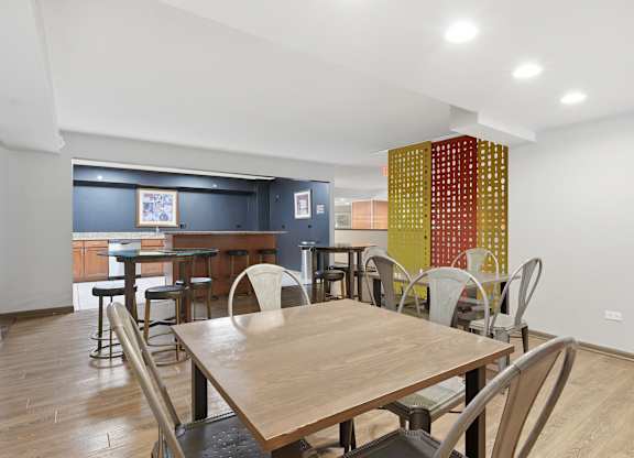 A dining room with a wooden table and chairs.
