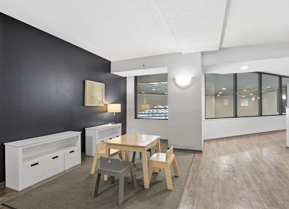 A modern dining room with a wooden table and chairs.
