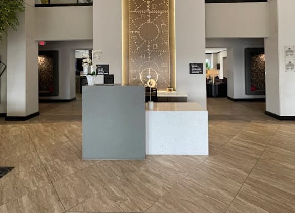 A reception area with a large golden door and a grey reception desk.