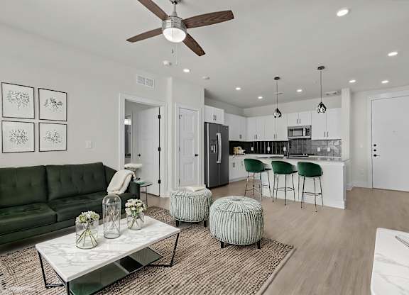 A modern living room with a green sofa and a coffee table.