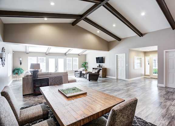 A large, modern dining room with a wooden table and chairs.