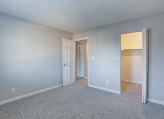 A room with a carpeted floor and white walls.