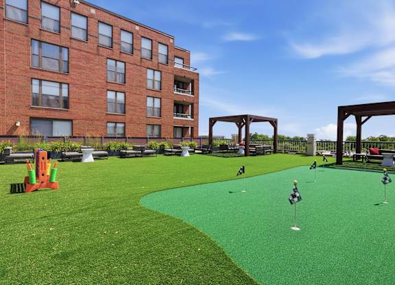 A rooftop green artificial turf putting green and outdoor games.