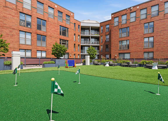 A rooftop green artificial turf putting green and outdoor games.