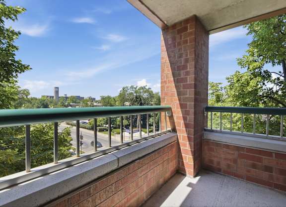 A corner balcony with a metal railing and view of Northwestern University.