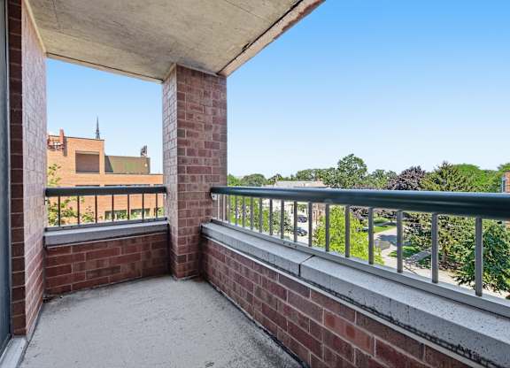 A corner balcony with a metal railing and view of Northwestern University.
