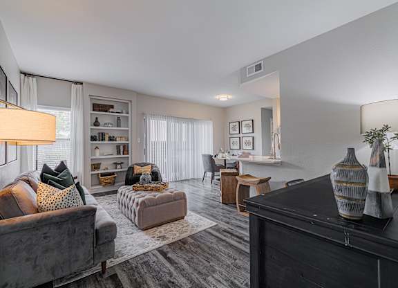spacious living room with couches and chairs and a dining room table