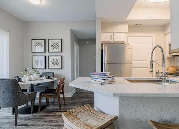 a kitchen and dining room with a sink and a refrigerator