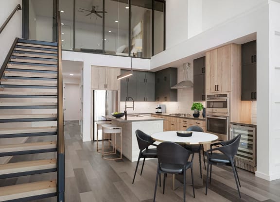 a kitchen and dining area with a white table and chairs