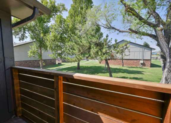 A wooden fence in the foreground with a residential area in the background.